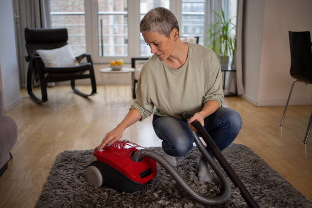 istock Woman vacuuming dust 1491646788