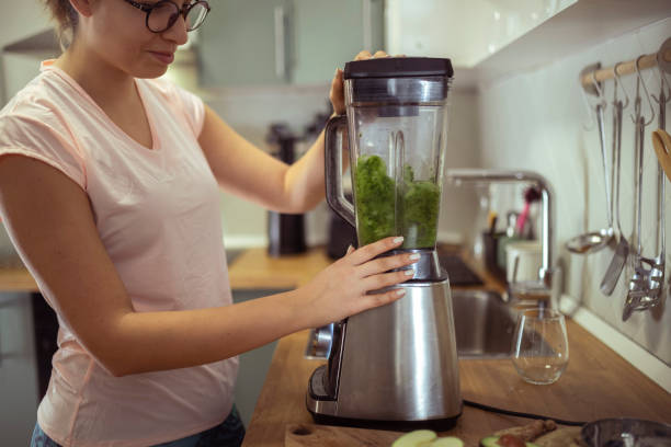 istock A woman uses a blender to make a refreshing, healthy smoothie 1491647098