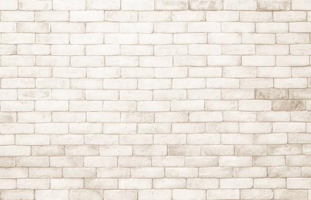 istock Empty background of wide cream brick wall texture. Beige old brown brick wall concrete or stone textured, wallpaper limestone abstract. Cream and white brick wall. Brickwork flooring pattern design. 1491647299
