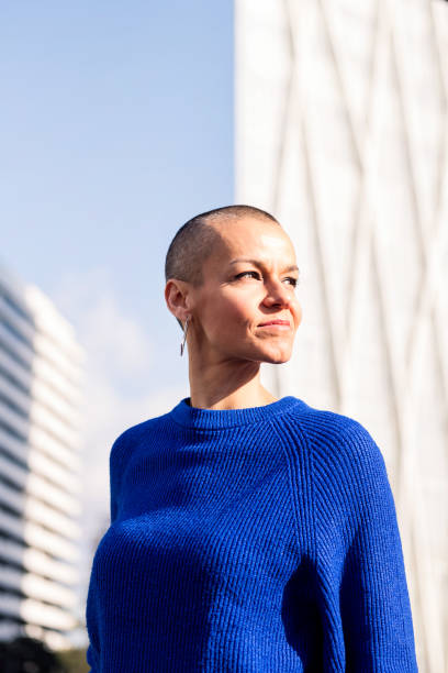istock empowered woman with shaved head in cityscape 1491647964