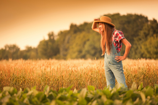 Subject: A young farm girl looking into the distance to her future and aspiration.