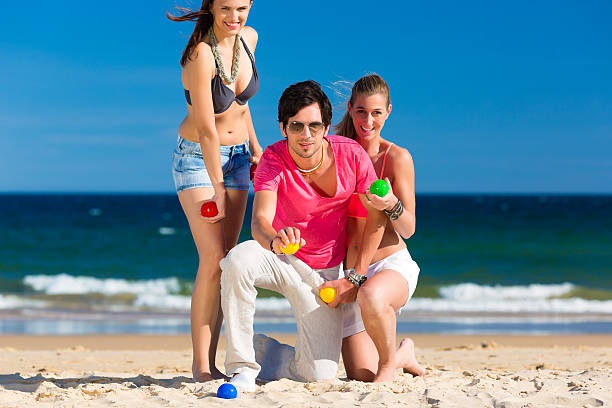 istock Man and women playing boule on beach 149165438