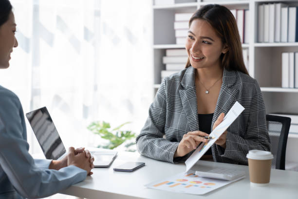 istock Two Asian businesswoman discussing new startup projects, presenting ideas, analyzing planning and financial statistics and investment markets with data graph documents at office. 1491655481