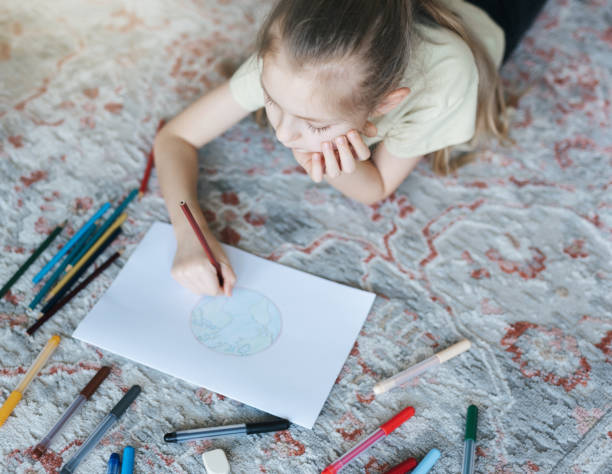 istock Child girl drawing with colorful pencils 1491656773