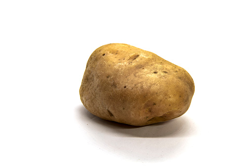 One raw washed potatoes isolated on white background. Side view.