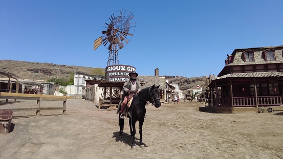 Gran Canaria - April 2023: Sioux City park offers the chance to interact with the park's cowboy actors, who are dressed in authentic Wild West costumes and act out various scenes throughout the day.