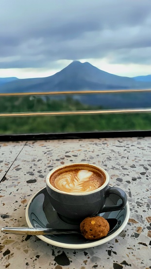 Enjoying beautiful view of Batur Montain Bali with a Cup Of Capucinno