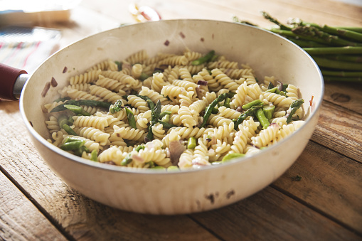Simple fusilli pasta with asparagus in cooking pan