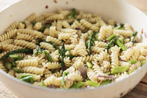 Simple fusilli pasta with asparagus in cooking pan