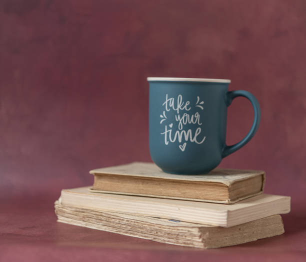 istock Pile of old books and a mug on a red background 1491664164