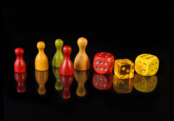 istock Yellow, red and green figures and playing dice on black background 1491665447