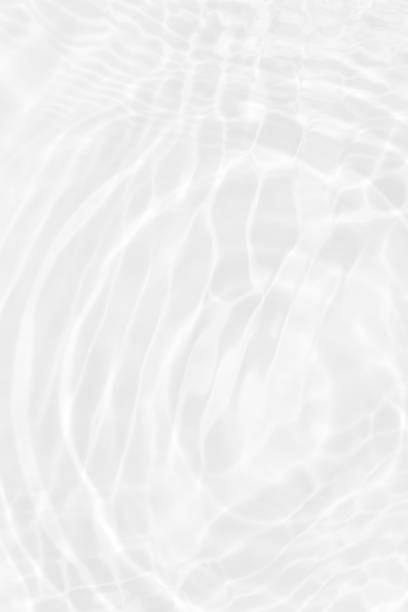istock White water with ripples on the surface. Defocus blurred transparent white colored clear calm water surface texture with splashes and bubbles. Water waves with shining pattern texture background. 1491665469