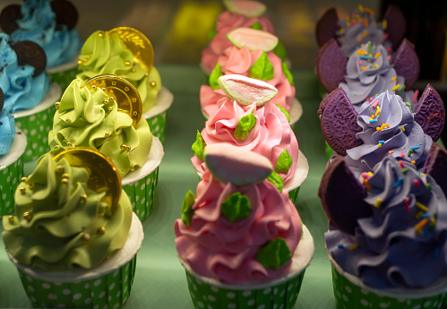 Many of mini tasty colorful cupcakes, in shallow focus