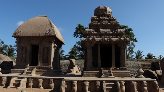This is five rathas as they resemble the processional chariots of a temple. Statues carved in rock. this is one features in several Hindu scriptures. blue sky backgrounds
