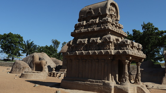 This is five rathas as they resemble the processional chariots of a temple. Statues carved in rock. this is one features in several Hindu scriptures. blue sky backgrounds