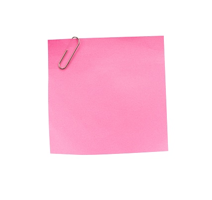 Pink note paper with paper clip isolated