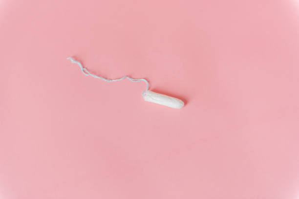 istock Woman white tampon pad isolated on a pink background 1491673469