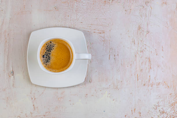 istock White cup of espresso on a light rustic background. 1491675838