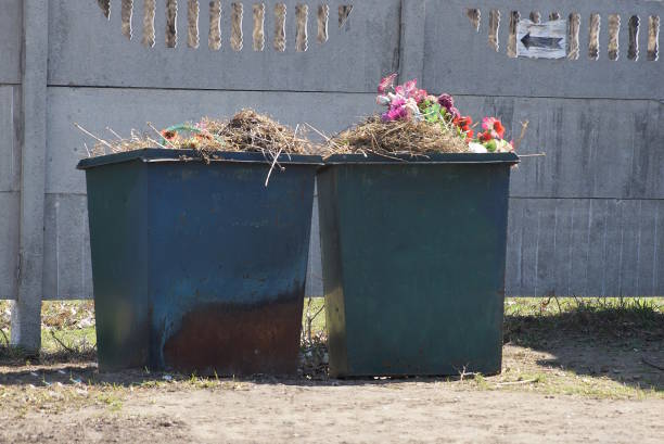istock two large metal full trash cans stand on the ground 1491676652