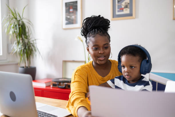 Plus size black mother working from home with her kid