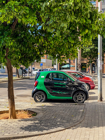 Valencia, Spain - June 6, 2021: 100% electric Smart car parked in the street. Almost every car manufacturer in the world is implementing an electric option for its cars