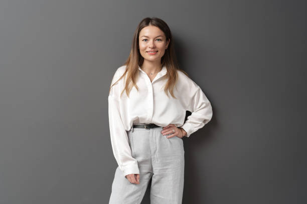 istock Happy young businesswoman posing over grey background 1491678855