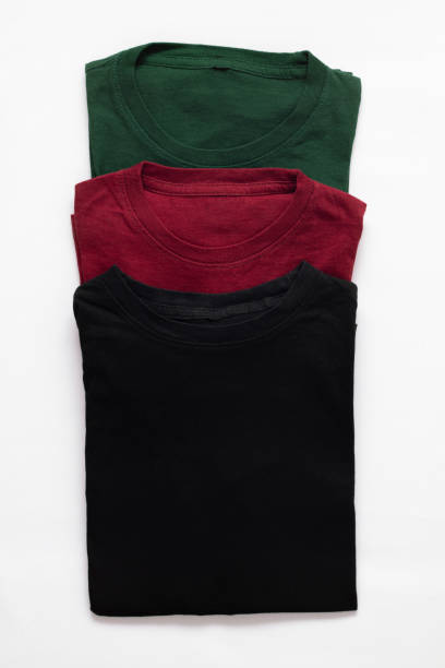 istock Folded black, dark red and green t-shirt with white background 1491679200