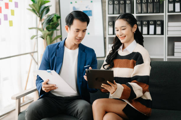 istock Two business workers talking on the smartphone and using laptop at the home office. 1491680671