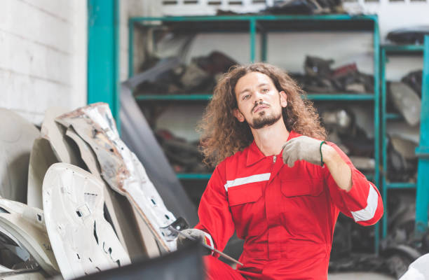 istock Mechanical man inspecting car parts stock on laptop computer while working in garage warehouse 1491680922