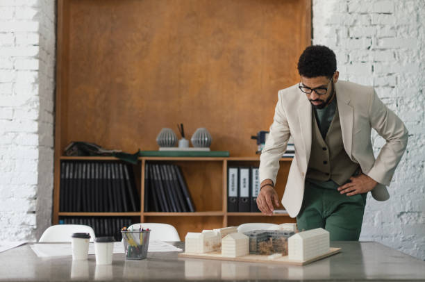 istock Young multiracial architect designing house in his office. 1491682293