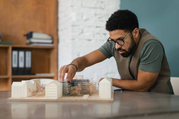istock Young multiracial architect designing house in his office. 1491682311