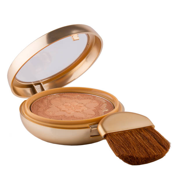 istock Bronzer powder for facial makeup in a plastic case with a mirror and a brush on a white background 1491682384