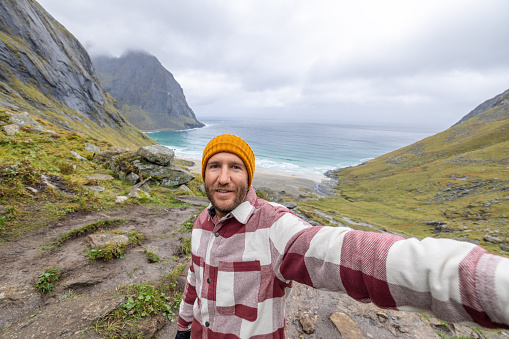 Young man hiking in a beautiful scenery in Norway.
Lofoten islands, Norway