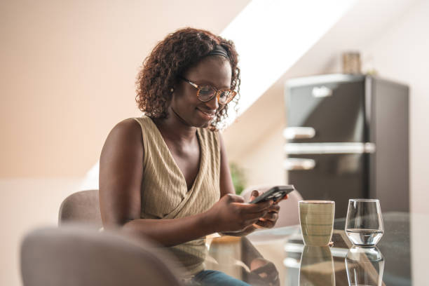 istock Black Female Text Messaging While Sitting In A Domestic Room 1491687947