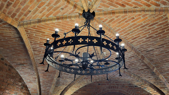 Old Chandelier in Interior Old Tower of the Trakai Castle. The Vintage Lamp Hanging From the Brick Ceiling