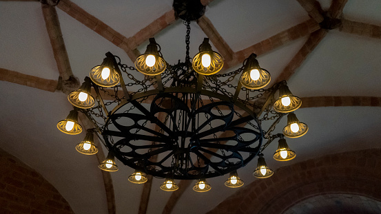 Old Chandelier in Interior Old Tower of the Trakai Castle. The Vintage Lamp Hanging From the Brick Ceiling