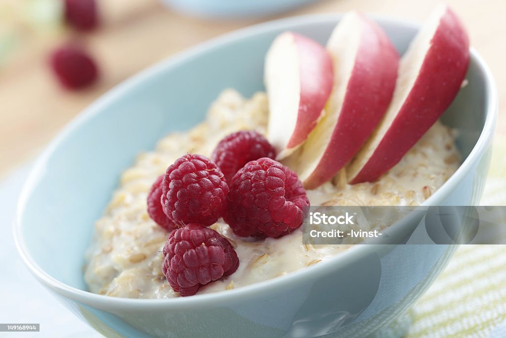 Oatmeal porridge with fruits Oatmeal porridge with raspberry and apple in a bowl Apple - Fruit Stock Photo