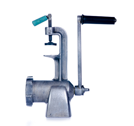 Old metal meat grinder on white background isolation