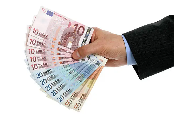 Businessmans hand holding european union currency against white background