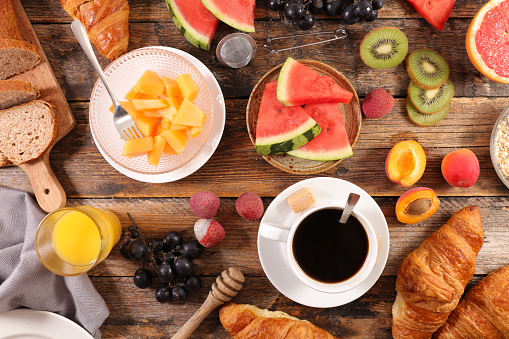 healthy breakfast- buffet food with coffee cuo, croissant and fruits
