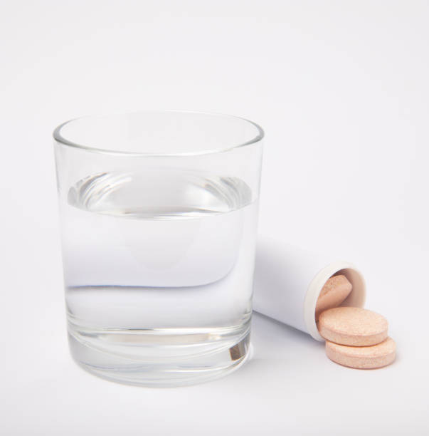 istock Glass with effervescent tablet in water. Isolated on white background. Vitamins. 1491697117