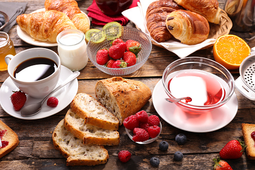 healthy breakfast with coffee, tea, croissant and fresh fruits