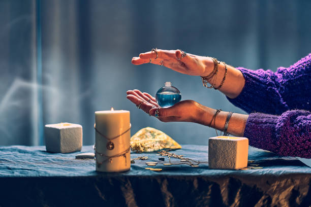 istock Magic witch woman with elixir potion bottle around candles and magical accessories during mystical alchemy witchcraft, sorcery and divination 1491698638