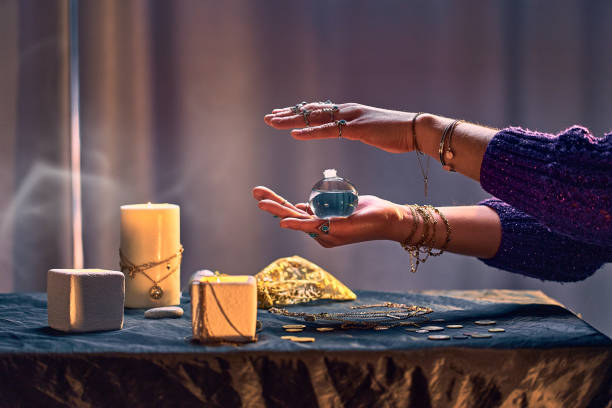 istock Witch female with elixir potion bottle around candles and magical accessories during mystical alchemy witchcraft. Magic concept 1491698639