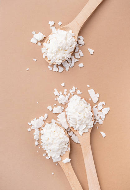 istock soy wax in wooden spoon on brown background, copy space 1491698865