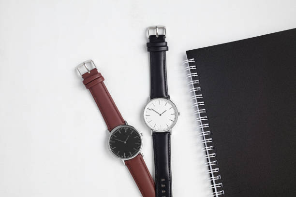 istock Watches with brown and black leather strap on white office desk 1491702458