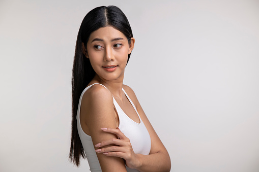 Attractive young Asian woman posing on white background