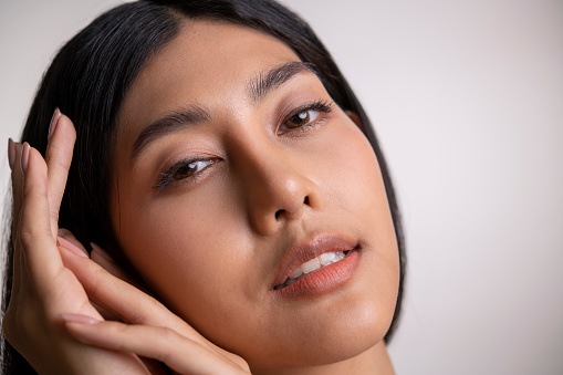 Close-up of Asian woman posing and looking  at camera