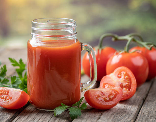 istock Glass of nutritious tomato juice and fresh tomatoes 1491702828
