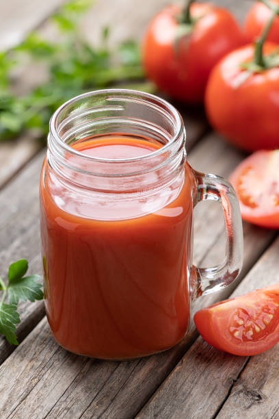 istock Glass of nutritious tomato juice and fresh tomatoes 1491702831